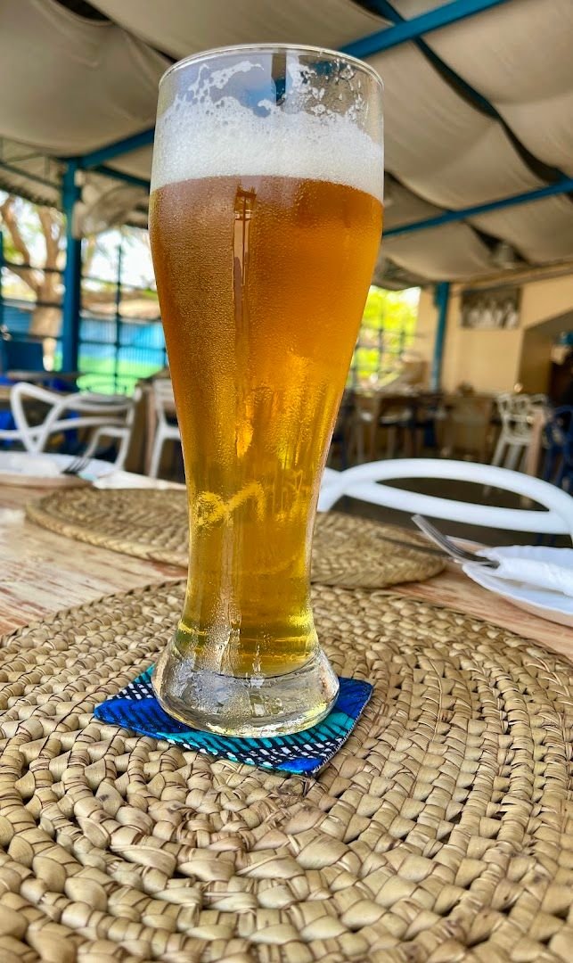 A cold glass of lager on Jolly's garden patio, condensation beading in the daylight