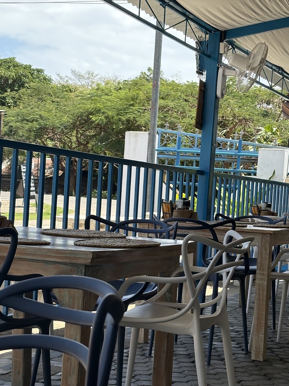 Jolly's sunny garden seating under a blue sky, tables set for a family lunch
